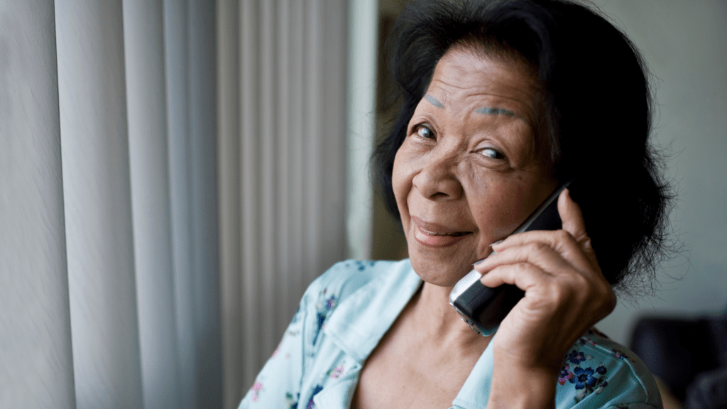 Photo of a senior woman smiling and talking on the phone.